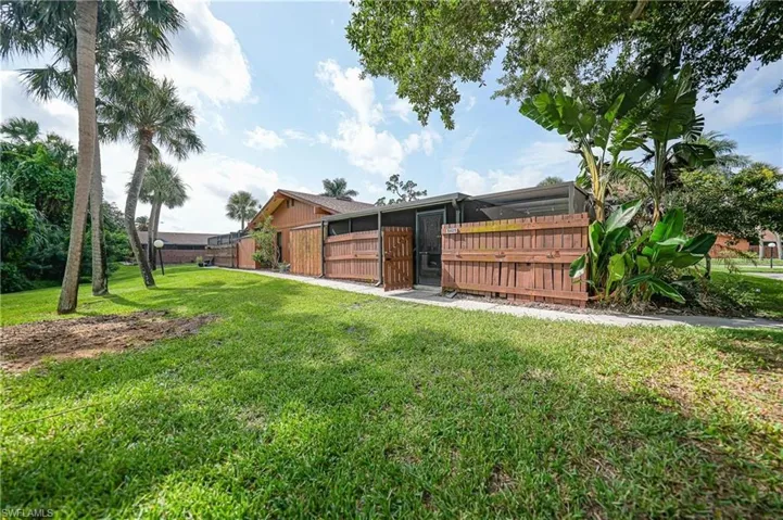 Manicured lawn with mature palm trees and tropical foliage