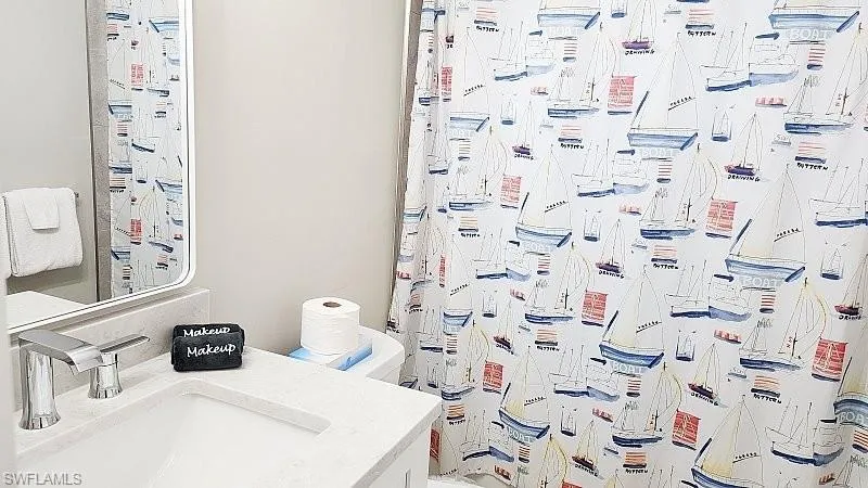 Full bath with vanity and a shower with curtain