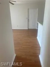 Hallway featuring dark wood-type flooring