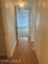 Hall featuring wood finished floors