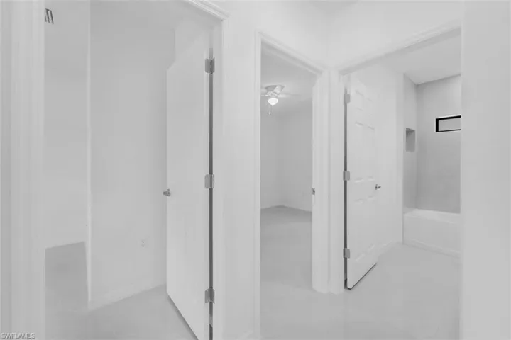 Full bath featuring light tile patterned floors and ceiling fan