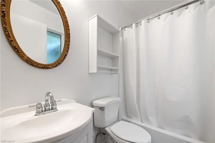 White vanity with an integrated sink and chrome faucet