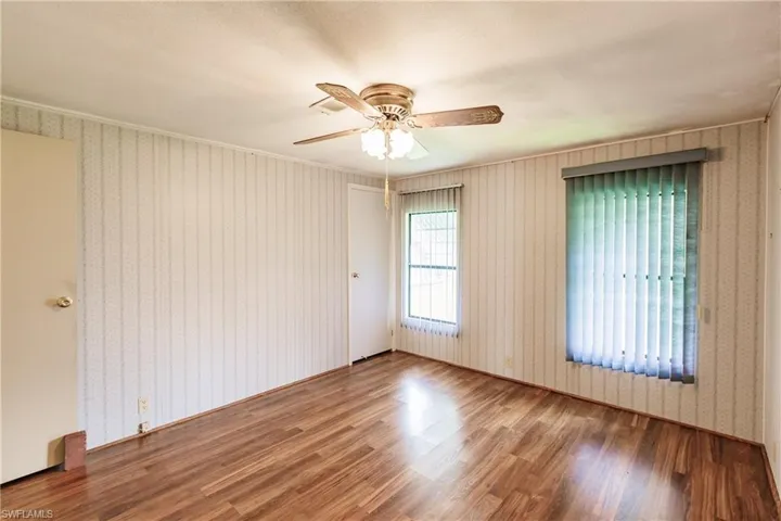 Empty room with ceiling fan and hardwood / wood-style floors