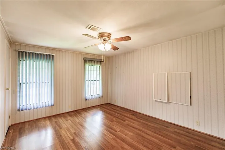 Unfurnished room with wood-type flooring and ceiling fan