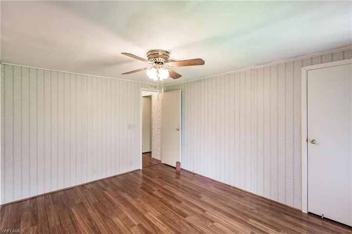Empty room featuring ceiling fan and wood-type flooring