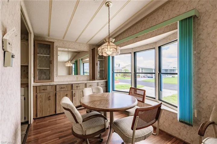 Dining area featuring dark hardwood / wood-style floors and vaulted ceiling