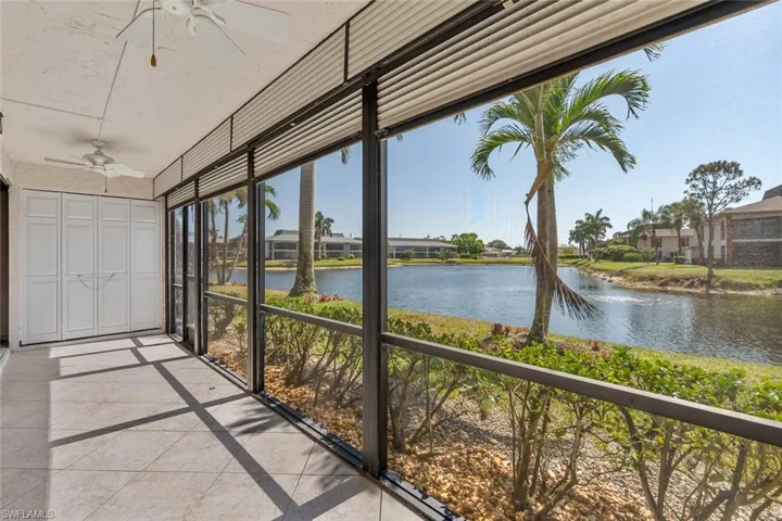 Unfurnished sunroom with ceiling fan, a healthy amount of sunlight, and a water view