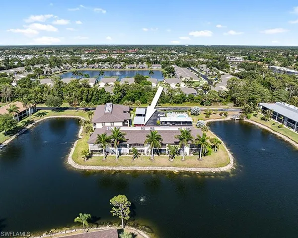 Birds eye view of property with a water view