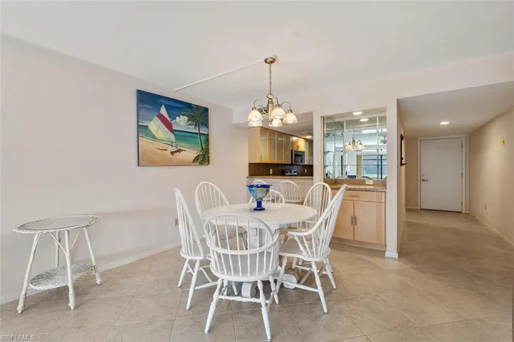 Tiled dining space featuring an inviting chandelier