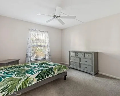 Carpeted bedroom with ceiling fan