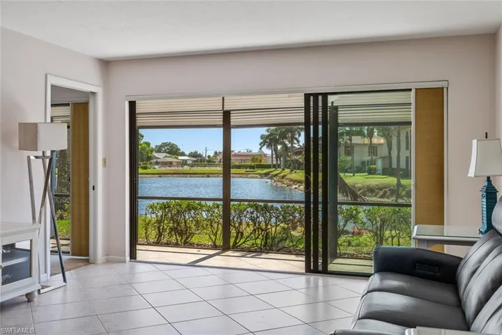 Tiled living room with a water view