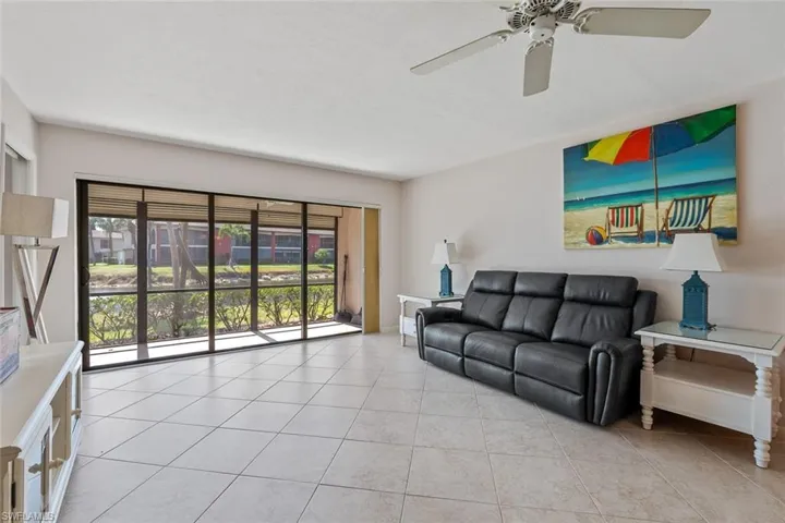 Tiled living room featuring ceiling fan