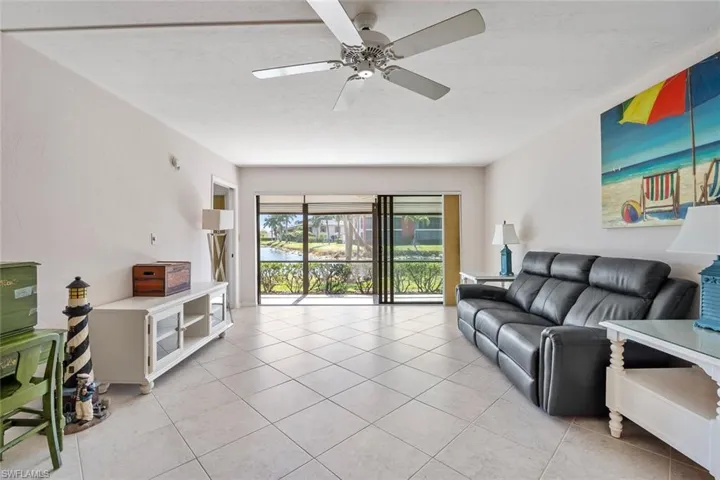 Tiled living room featuring ceiling fan