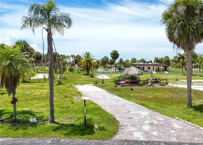 View of property's community with a lawn