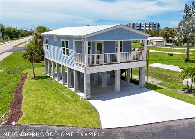 Coastal inspired home featuring covered porch, a carport, and a front yard