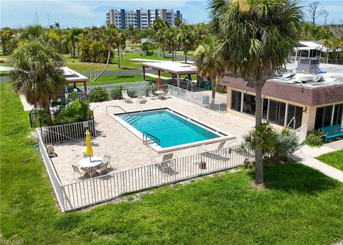 View of swimming pool featuring a patio and a yard
