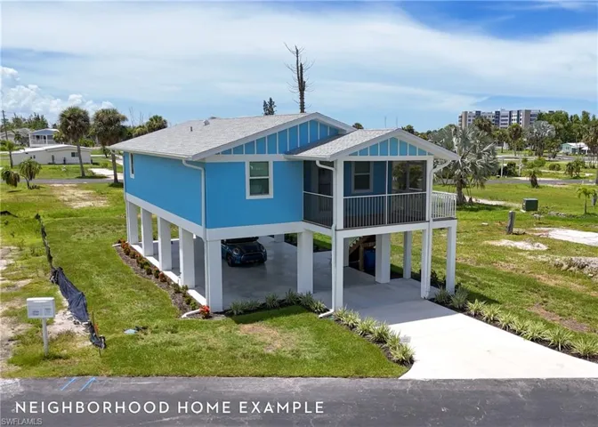 View of front of home featuring a carport and a front yard