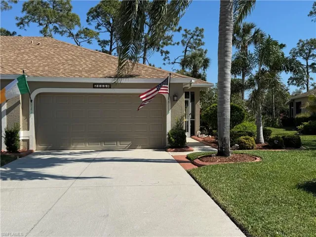 View of front of house featuring stucco siding, roof with shingles, concrete driveway, a front yard, and a garage
