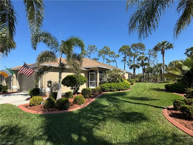 View of side of home with concrete driveway, a lawn, a garage, and stucco siding