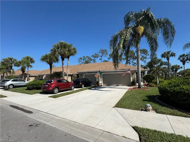Single story home with a garage, a front lawn, and driveway