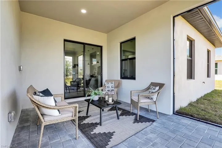 Covered patio featuring paver flooring, recessed lighting, and a sliding glass door  photos used from another listing to show what it would look like with furniture