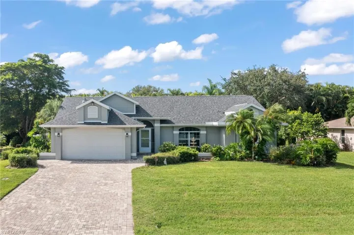 Ranch-style home with a garage and a front yard