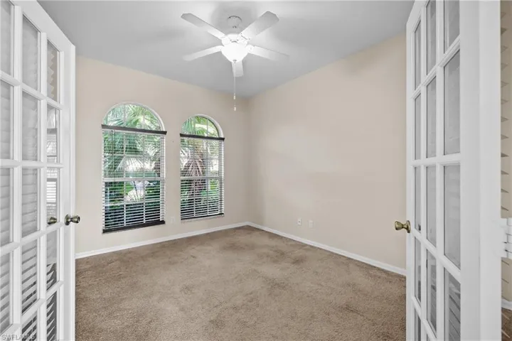 Den featuring french doors, carpet floors, and ceiling fan