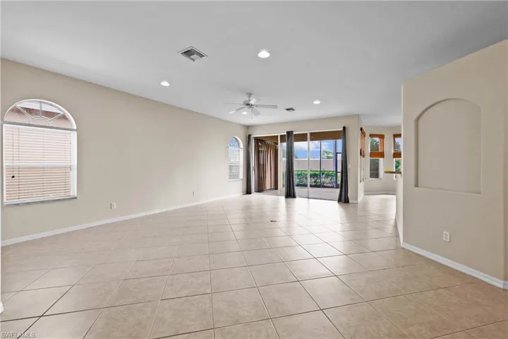 Living room featuring light tile patterned flooring, recessed lighting, and ceiling fan