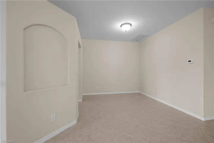 Dining Room with light tile patterned floors and baseboards