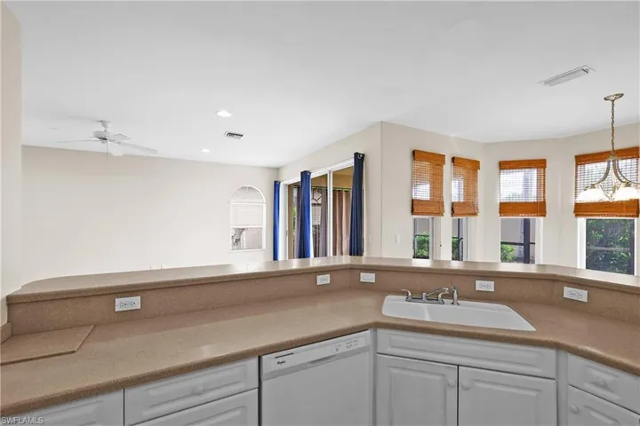 Kitchen featuring white cabinets, dishwasher, recessed lighting, and light counters