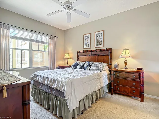 Carpeted bedroom with ceiling fan