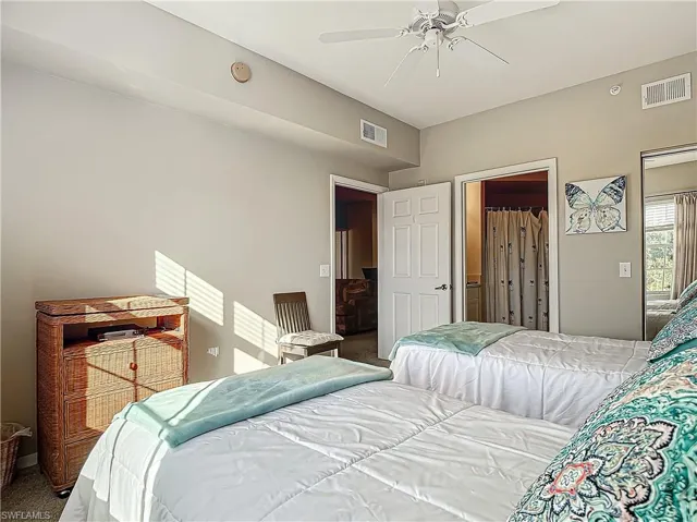 Carpeted bedroom featuring ceiling fan