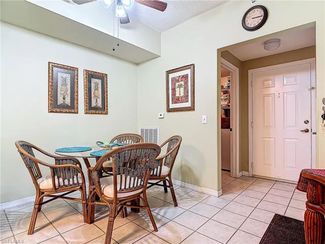Dining room with ceiling fan and light tile patterned flooring