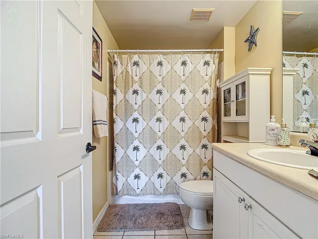 Bathroom featuring tile patterned floors, vanity, and toilet