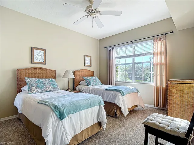 Bedroom featuring ceiling fan and carpet floors