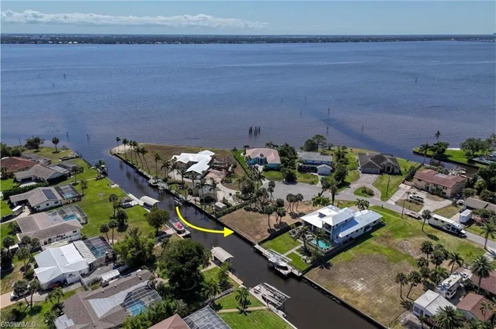 Aerial perspective of suburban area with a nearby body of water