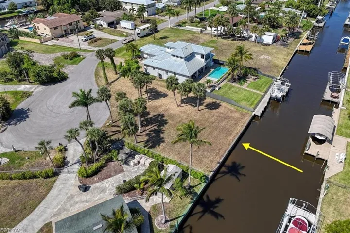 Aerial overview of property's location with a nearby body of water and nearby suburban area