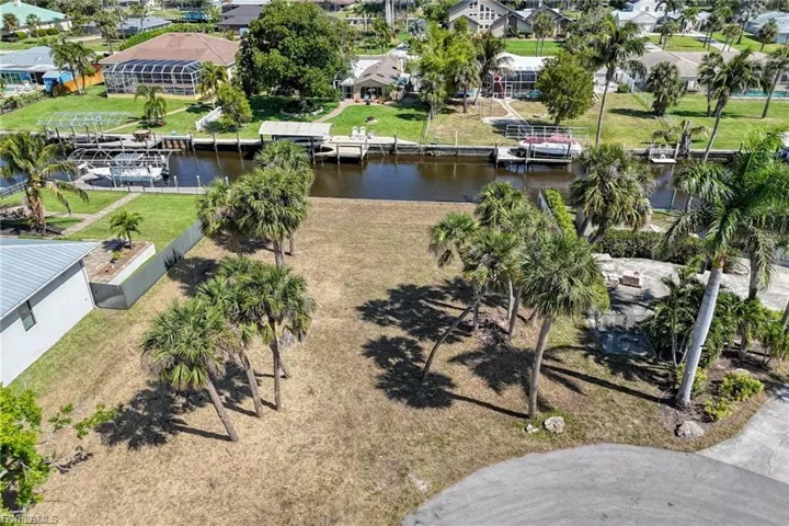 Aerial view of residential area featuring a nearby body of water