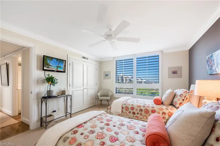 Views to the west, custom closet, paddle fan, molding and pretty accents make this room so attractive.