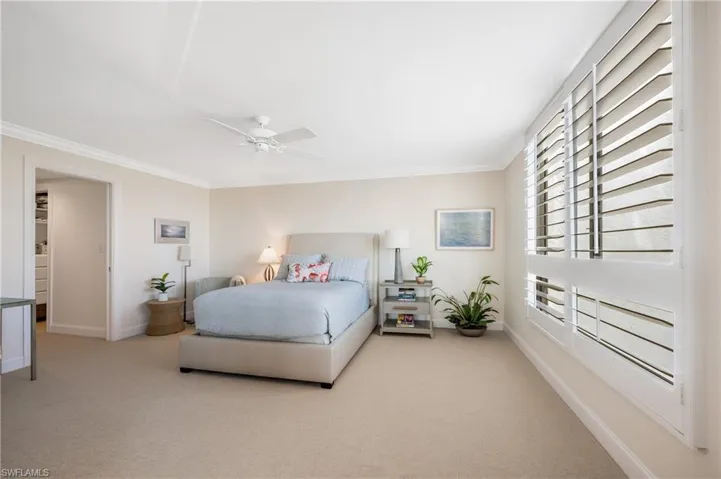 Welcome to your retreat!  So calm and peaceful with a view of the bay.  All enhanced with shutters, paddle fan, crown molding, it is the ideal master bedroom suite.