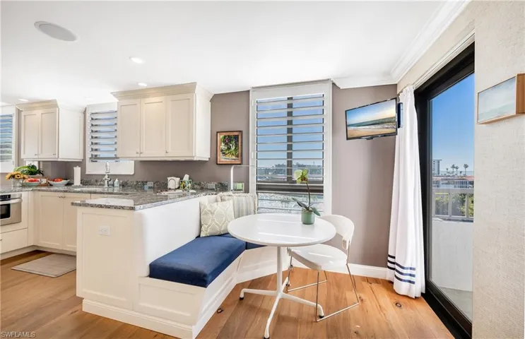 The eat-in kitchen is a wonderful space to start your day with a view to the balcony and west.