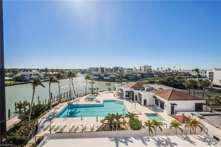 View of pool featuring a patio area and a water view.  Enjoy all the amenities of Admiralty Point for an enjoyable resort lifestyle!