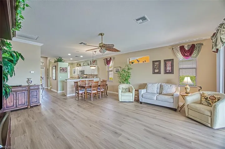 Living room featuring ceiling fan and light hardwood / wood-style floors