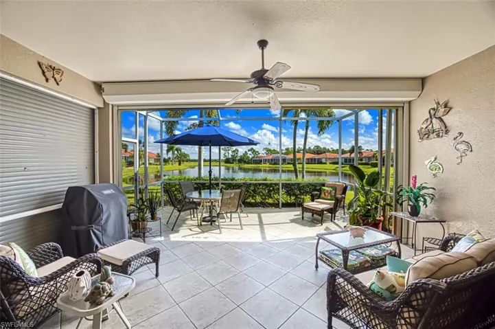 Sunroom / solarium with a water view and ceiling fan