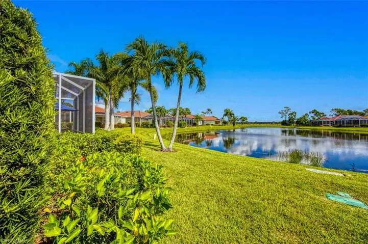 View of yard with a lanai and a water view