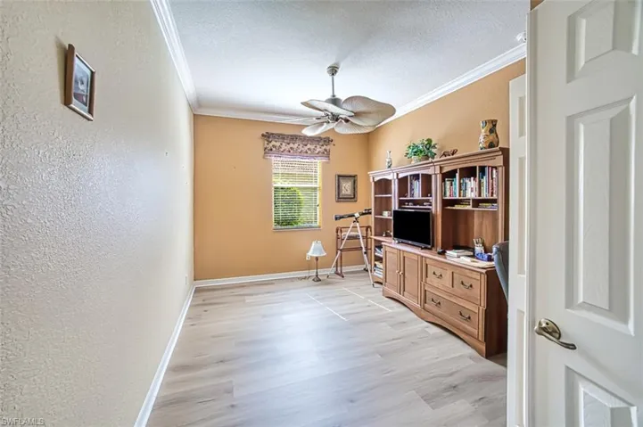 Office area featuring crown molding, a textured ceiling, ceiling fan, and light hardwood / wood-style floors