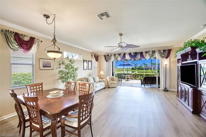 Dining space with a wealth of natural light, ceiling fan, and light hardwood / wood-style floors