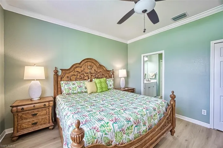 Bedroom featuring crown molding, ceiling fan, ensuite bathroom, and light hardwood / wood-style floors