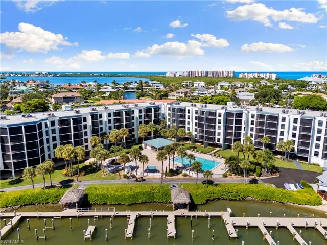 Drone / aerial view of a nearby body of water and apartment complex