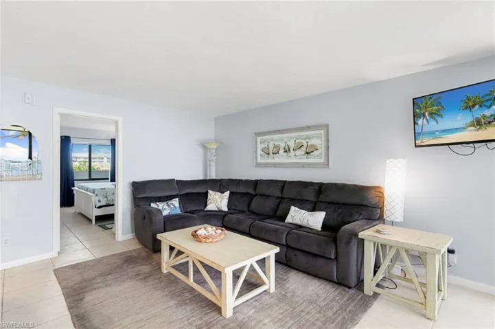 Living area with light tile patterned floors and baseboards